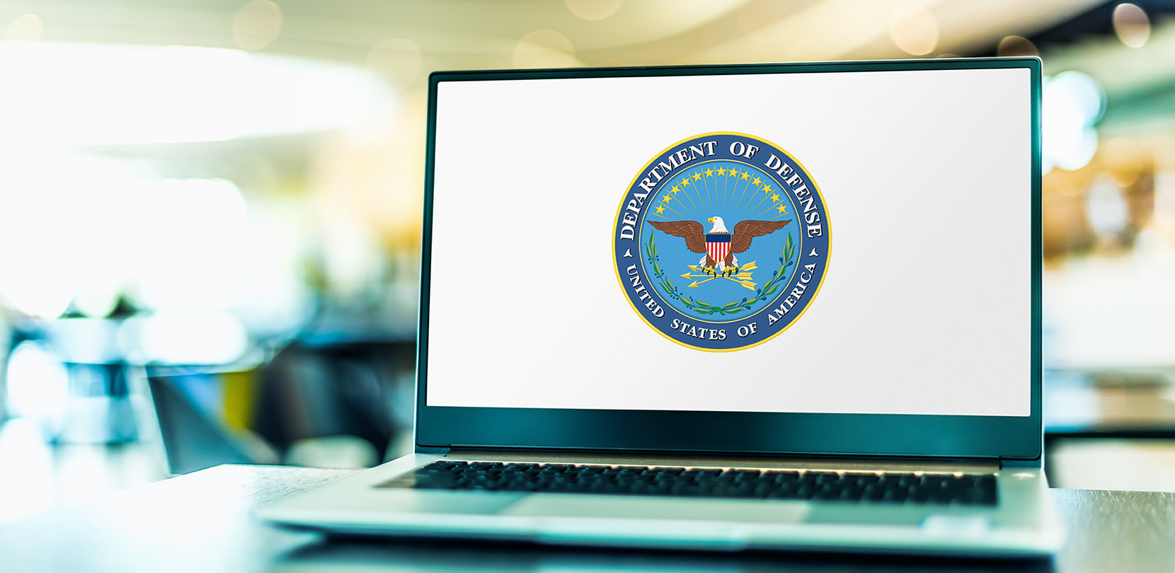 A computer displaying the DoD logo